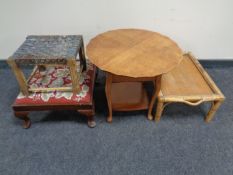 A 20th century sewing table together with a bamboo and wicker bed tray and two further foot stools.