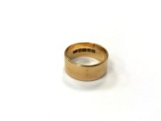 An 18ct yellow gold band ring, 8.9g, band width 9 mm.