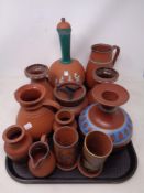 A tray containing 12 pieces of terracotta pottery including lidded pot jug vases etc.