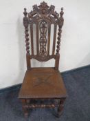 An Edwardian carved oak barley twist hall chair.