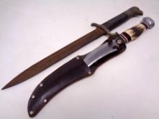A German eagle head pommel bayonet, lacks scabbard, together with a hunting knife in leather sheath.