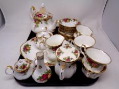 A tray containing 25 pieces of Royal Albert Country Roses tea china together with a bud vase.