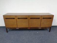 A 20th century teak six-piece dining room suite comprising extending dining room table,