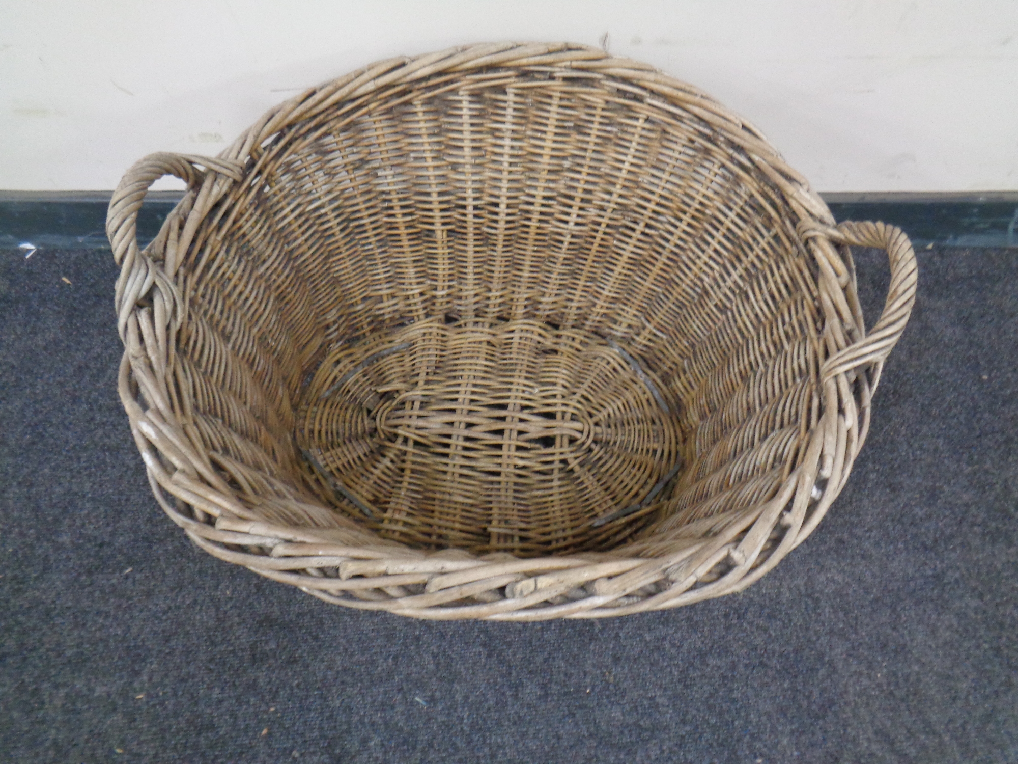 A wicker twin handled log basket.