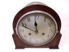 An oak cased 8 day mantel clock with silver dial.