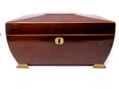 A good quality Regency mahogany sarcophagus tea caddy on raised brass feet containing a Chinese