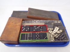 A tray containing vintage dominoes and cribbage pegboards.