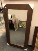 A contemporary mirror in a brown leather effect frame, 71cm x 130cm.