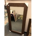 A contemporary mirror in a brown leather effect frame, 71cm x 130cm.