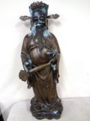 A cast patinated metal figure of a Chinese immortal (height 77.5cm).