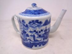 A Chinese blue and white glazed ceramic teapot depicting a traditional scene (height 14cm) together