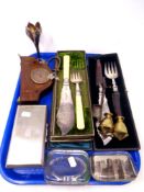A tray containing cased plated servers, a plated cigarette box, vintage glass paperweights,