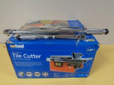 A Nutool tile cutter (boxed) together with two wrenches.