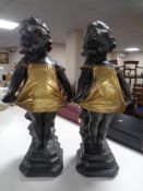 A pair of painted chalk figures of shy girls.