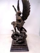 A bronze figure of Archangel St. Michael slaying the dragon on a black marble base (height 53cm).