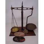A set of 19th century chemist's pan scales mounted on a board with weights together with a pair of