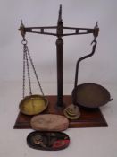 A set of 19th century chemist's pan scales mounted on a board with weights together with a pair of