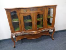 A late 19th century walnut bow fronted chiffoniere base on raised legs