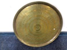 A circular Eastern brass plaque (width 58cm).