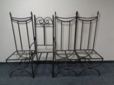 A wrought iron scroll armchair together with three further high backed chairs