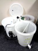 A home brewery bin together with two fermentation bins and further brewing accessories.