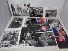 A box containing a quantity of black and white and colour library photographs depicting musicians