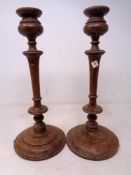 A pair of Edwardian wooden candlesticks.