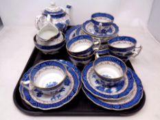 A tray containing a 22 piece Booth's Real Old Willow china tea service.
