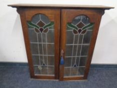 An Edwardian oak leaded glass door bookcase