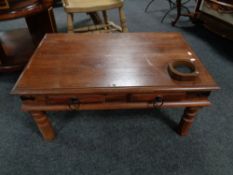 A sheesham wood coffee table fitted with two drawers.
