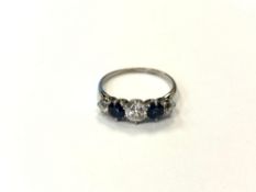 An early 20th century three stone diamond and sapphire ring, 1.9g, ring size N, 5.