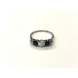 An early 20th century three stone diamond and sapphire ring, 1.9g, ring size N, 5.