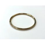 A 9ct gold bangle, 6.6g, diameter approximately 6.5 cm.