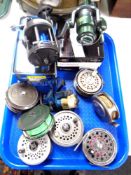 A tray containing assorted fishing reels.