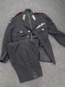 A St. John's Ambulance two-piece uniform with badges and buttons.