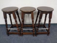 A set of three circular bar stools.