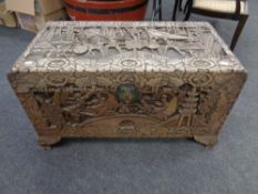 A heavily carved camphor wood box.