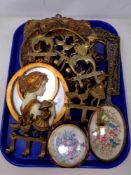 A tray containing dressing table pieces, brass picture frames and coat hooks,