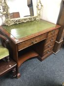 A good quality Regency style mahogany single pedestal writing desk with a green leather inset panel