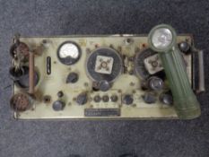 A World War II era Wireless Set No.19 MK III radio together with a vintage torch.