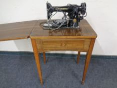 A Singer electric sewing machine in table.