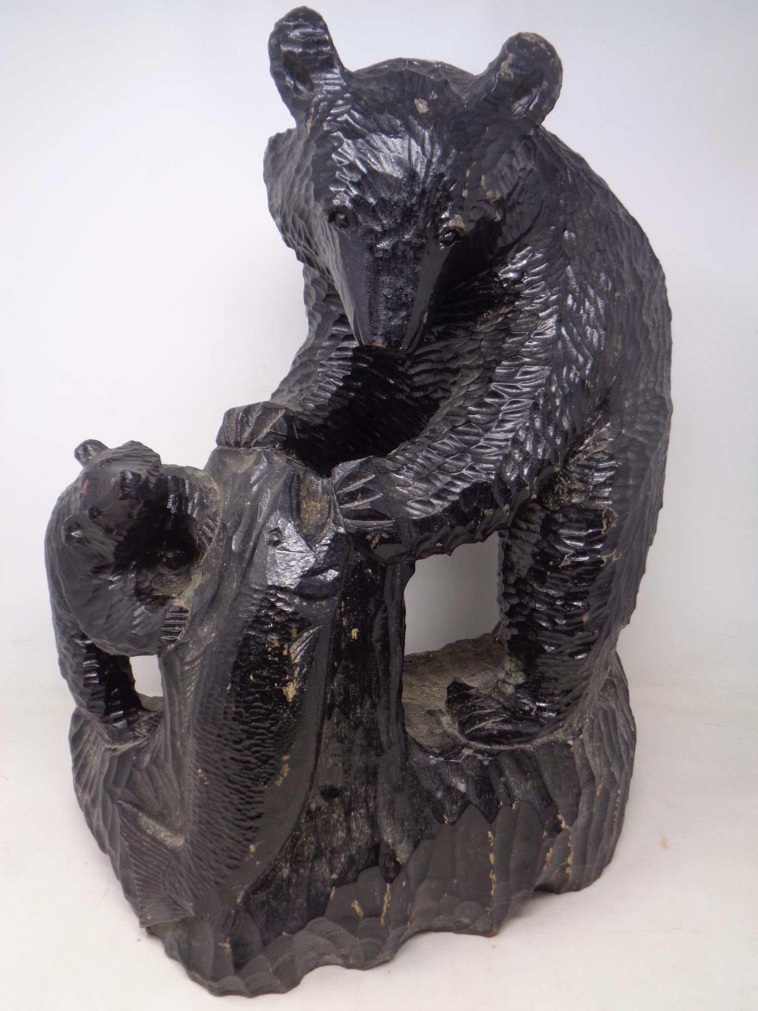 A carved black forest style figure group of a bear with cub (height 47cm).