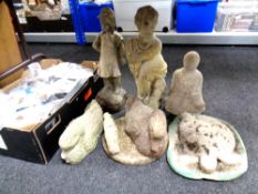 Eight assorted concrete garden ornaments and plaques.