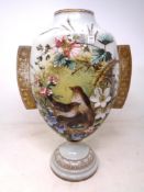 A 19th century hand painted glass vase depicting birds on a nest in foliage (height 36.5cm).