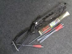 A crossbow together with a quantity of crossbow bolts.