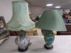 Two Chinese style floral ceramic table lamps on wooden bases with shades.