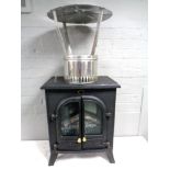 An electric heater in the form of a stove together with a chimney flue.
