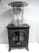 An electric heater in the form of a stove together with a chimney flue.