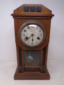 An Edwardian oak cased 8 day mantel clock with silver dial.