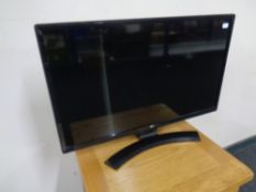 An LG 28 inch LCD TV with lead and remote.